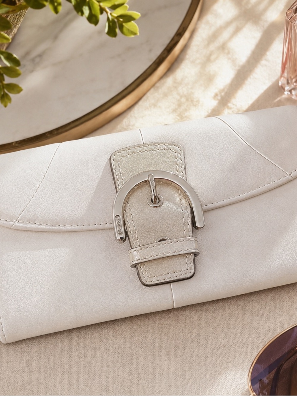 Coach Soho Leather Buckle Slim Envelope Wallet featuring a metallic buckle